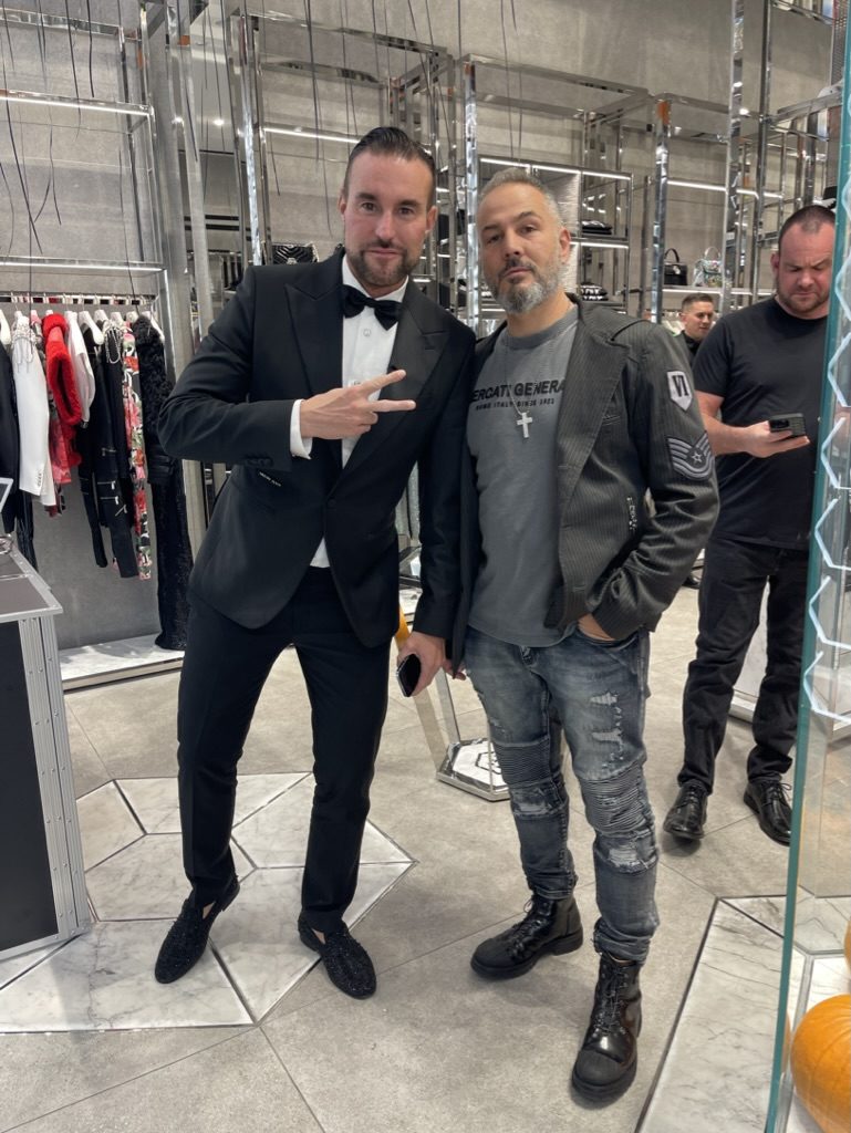 Marco with a friend at a fashion boutique